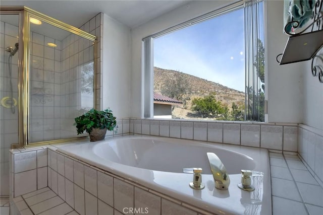 bathroom featuring tile patterned floors, a mountain view, and shower with separate bathtub