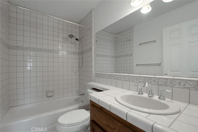 full bathroom with vanity, backsplash, toilet, and tiled shower / bath