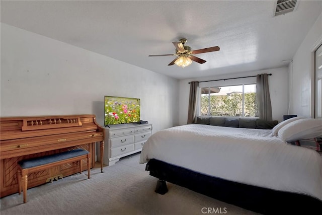 bedroom with ceiling fan and light colored carpet