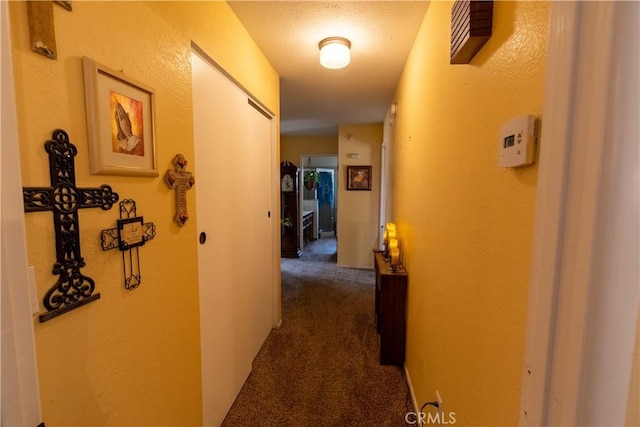 hallway with dark carpet