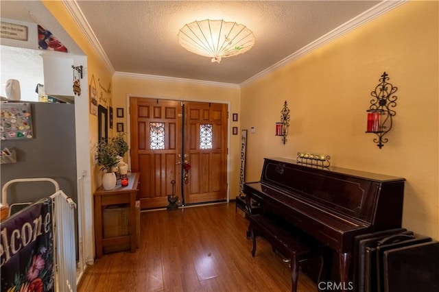 foyer entrance featuring ornamental molding, hardwood / wood-style floors, and a textured ceiling