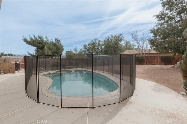 view of pool with an in ground hot tub and a patio area