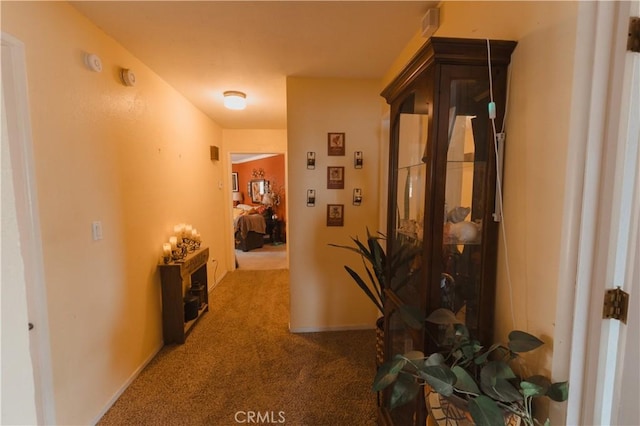 corridor featuring dark colored carpet