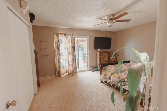 bedroom with a textured ceiling, light carpet, access to outside, a closet, and ceiling fan