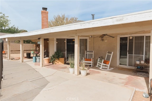 rear view of property with a patio and ceiling fan