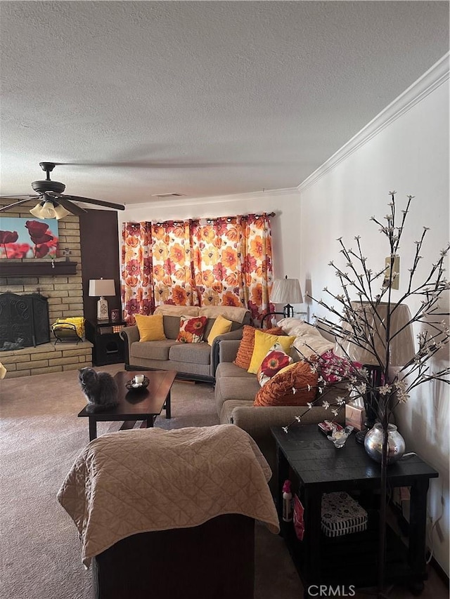 carpeted living room featuring crown molding, ceiling fan, a stone fireplace, and a textured ceiling