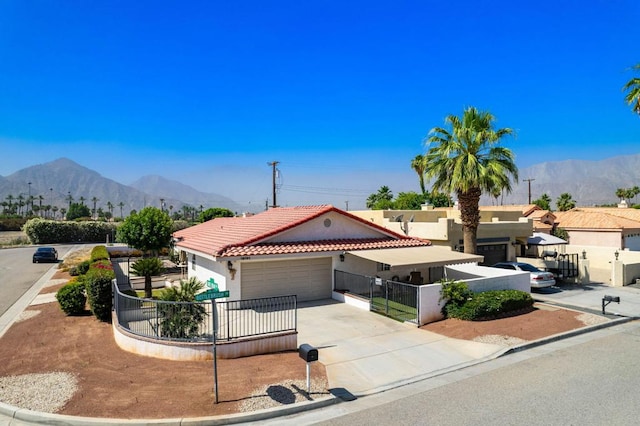 view of front of house with a mountain view and a garage