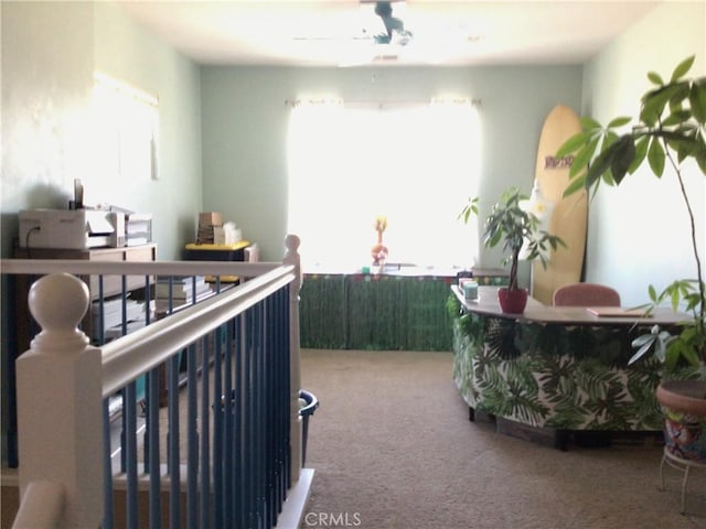 interior space featuring carpet flooring, ceiling fan, and plenty of natural light