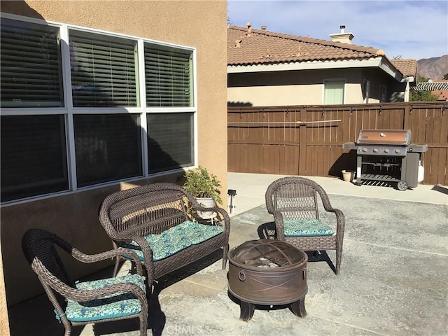 view of patio / terrace with area for grilling and a fire pit