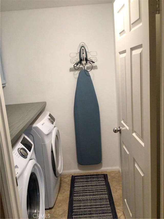 clothes washing area featuring light tile patterned floors and separate washer and dryer