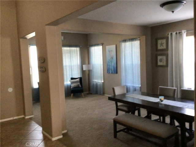 dining room with dark colored carpet