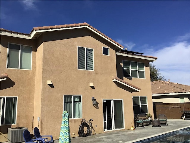 back of property with a patio and central AC unit