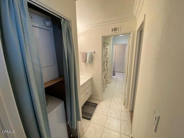 bathroom featuring crown molding, tile patterned flooring, and vanity