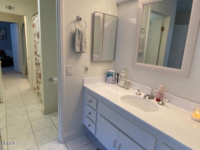 bathroom featuring tile patterned flooring and vanity