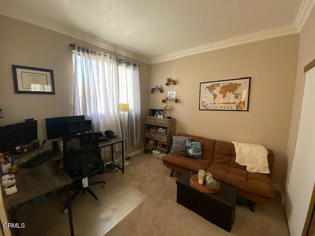 home office featuring light carpet and ornamental molding