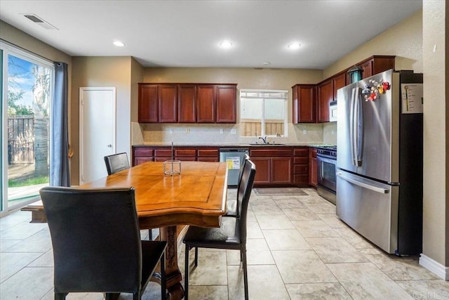 31616 Umbria Ln, Winchester, CA 92596 - kitchen with light tile patterned floors, tasteful backsplash, visible vents, stainless steel appliances, and a sink