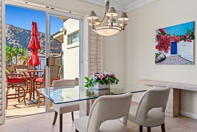 dining room featuring a chandelier, a mountain view, crown molding, and light tile patterned flooring