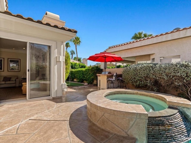 view of patio / terrace featuring an in ground hot tub and exterior bar