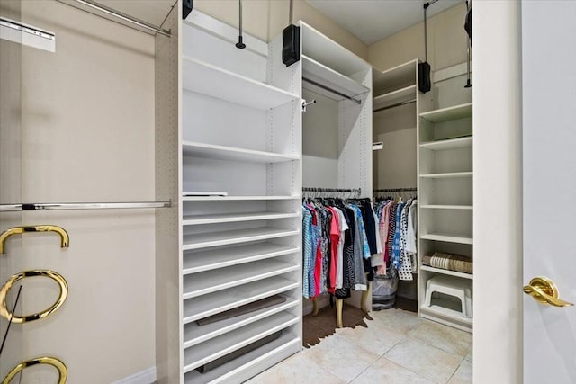 spacious closet featuring light tile patterned floors