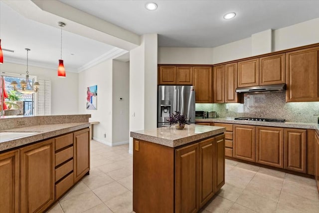 kitchen with a center island, stainless steel refrigerator with ice dispenser, backsplash, crown molding, and pendant lighting