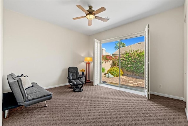 sitting room with carpet floors, plenty of natural light, and ceiling fan