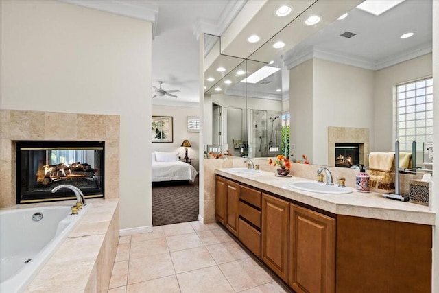 bathroom featuring a multi sided fireplace, crown molding, tile patterned floors, and ceiling fan