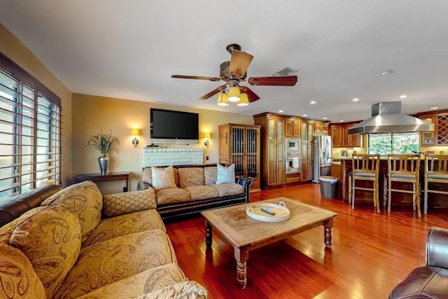 living room featuring ceiling fan and wood-type flooring