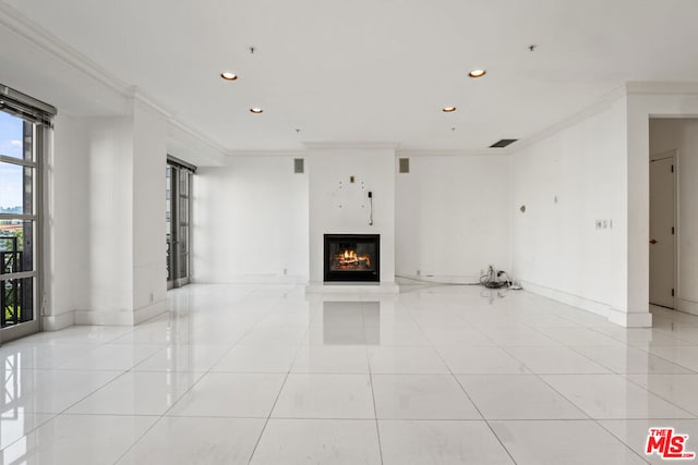 unfurnished living room with light tile patterned floors and ornamental molding