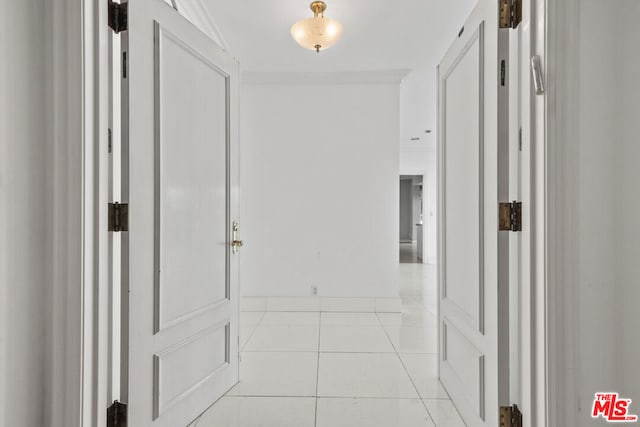 hall with light tile patterned floors