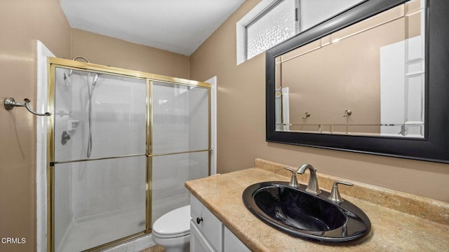 bathroom featuring vanity, toilet, and walk in shower