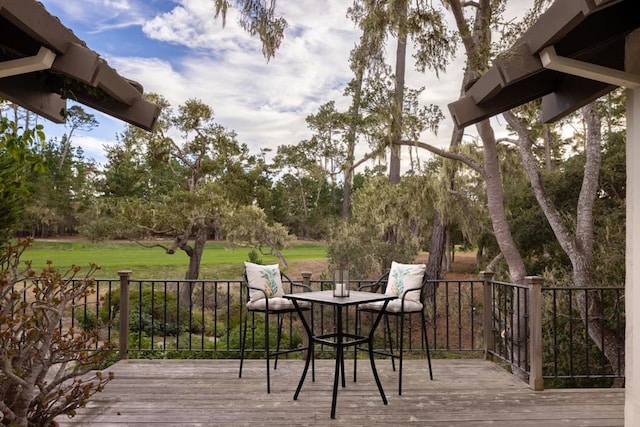 wooden deck featuring a lawn