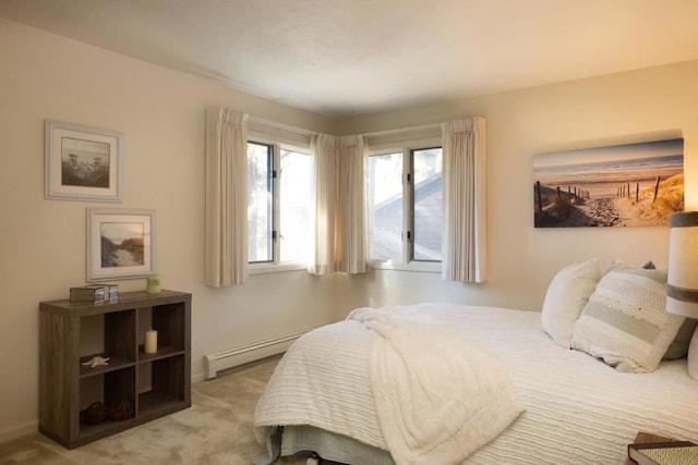 bedroom featuring baseboard heating and light colored carpet