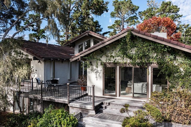 rear view of property with a wooden deck