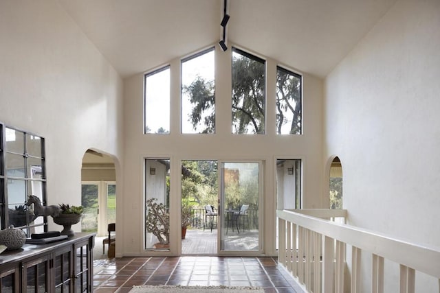 tiled entryway with high vaulted ceiling