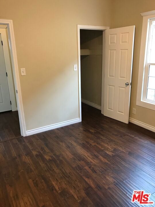 spare room featuring dark hardwood / wood-style floors