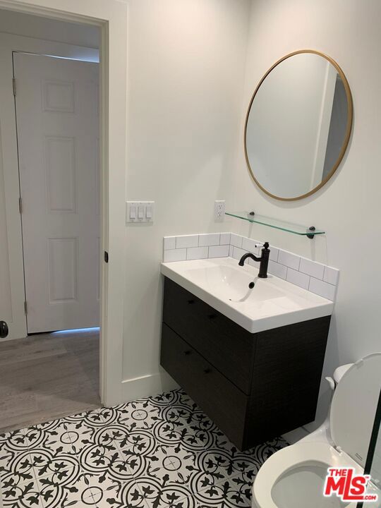 bathroom featuring hardwood / wood-style flooring, vanity, and toilet