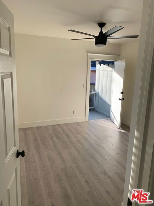 spare room with ceiling fan and light hardwood / wood-style floors