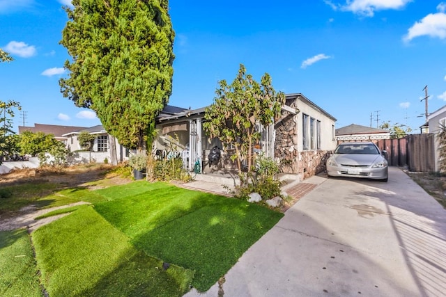 view of front of house with a front yard and solar panels