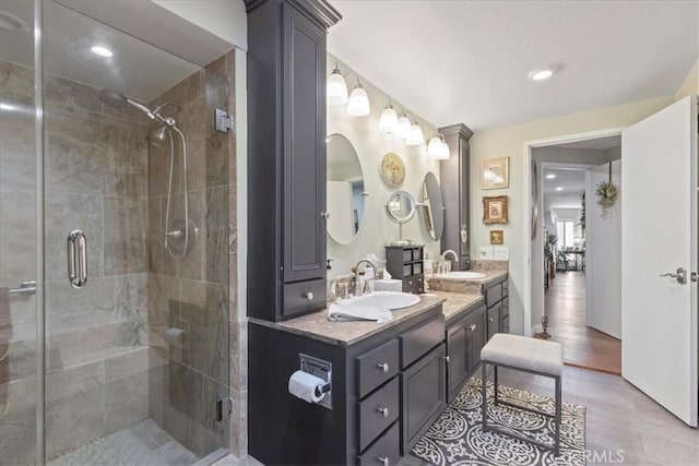 bathroom with a shower with door, vanity, and hardwood / wood-style flooring