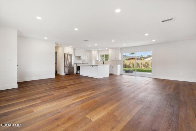 unfurnished living room with light wood-type flooring and sink