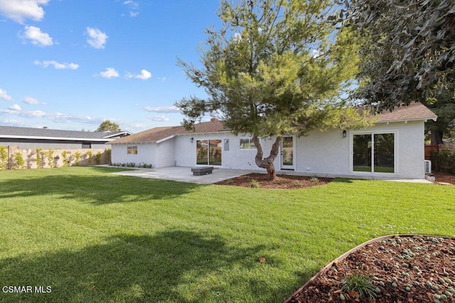 rear view of house featuring a patio area and a lawn