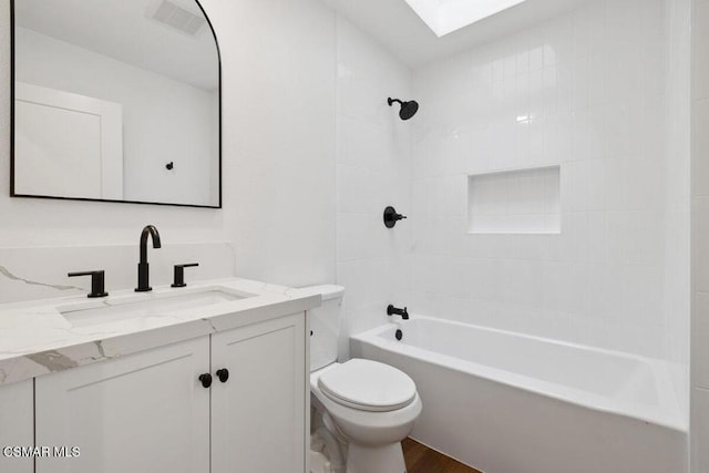 full bathroom with vanity, toilet, wood-type flooring, and tiled shower / bath