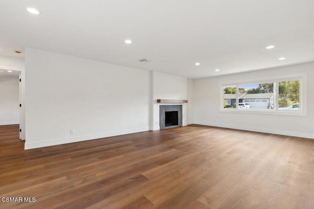 unfurnished living room featuring hardwood / wood-style flooring