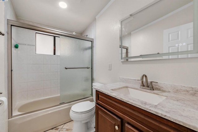 full bathroom featuring tile patterned floors, vanity, toilet, and enclosed tub / shower combo