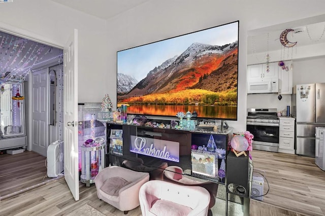 interior space featuring hardwood / wood-style flooring and appliances with stainless steel finishes