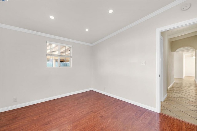 unfurnished room featuring wood-type flooring and ornamental molding