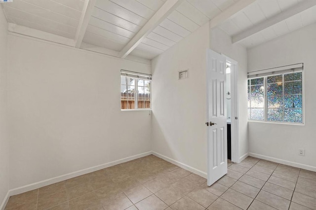 unfurnished room with beamed ceiling, light tile patterned floors, and wood ceiling