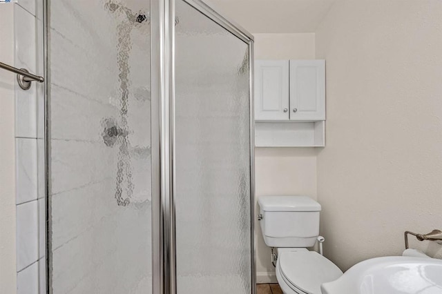 bathroom featuring toilet and walk in shower