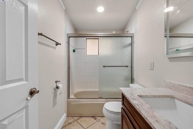 full bathroom featuring tile patterned flooring, vanity, bath / shower combo with glass door, and toilet