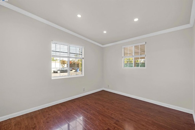 spare room with plenty of natural light, dark hardwood / wood-style floors, and ornamental molding